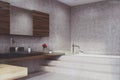 Concrete bathroom, tub and sink, corner toned Royalty Free Stock Photo