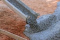 The concrete is being poured in the course of paving a driveway at a construction site on the site of a near new home. Royalty Free Stock Photo