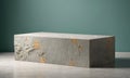 A concrete block with gold flecks sits in front of a teal wall Royalty Free Stock Photo