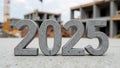 Concrete block numbers 2025 on blurred construction site background Royalty Free Stock Photo