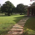 Concrete block path on the green lawn in Dominicana