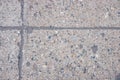 Concrete blocks with joints. Weathered asphalt road top view. Old grungy concrete with stone pebble relief. Grungy concrete Royalty Free Stock Photo