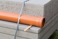 Concrete blocks and plastic pvc sewage pipe on palette on construction site Royalty Free Stock Photo
