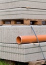 Concrete blocks and plastic pvc sewage pipe on palette on construction site Royalty Free Stock Photo
