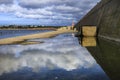 Concrete blocks on a puddle of water with reflections in Baleeira Port Royalty Free Stock Photo