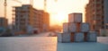 Concrete blocks stacked on surface, construction site background at sunset. Buildings and cranes visible in soft focus warm Royalty Free Stock Photo