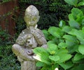 Concrete boy cross-legged, garden statuette Royalty Free Stock Photo