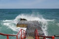 Concrete breakwater and crashed wave noise.