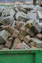 Concrete bricks construction material laying in skip on each other heap