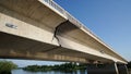 Damaged concrete bridge structure over a river with clear blue sky Royalty Free Stock Photo
