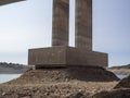 Concrete bridge under construction over a reservoir