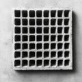 Concrete building block with a grid pattern showcased on a plain background highlighting texture and design