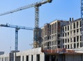 Concrete building construction site with cranes in blue sky Royalty Free Stock Photo