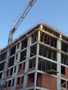 Concrete building under construction with crane and visible framework. Architecture, engineering, and urban development process in Royalty Free Stock Photo