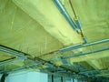 A concrete ceiling surface that has been sprayed with a layer of polyurethane foam.