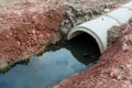 Concrete circular run-off pipe discharging water. sewage pipe polluting the river. Sewage or domestic wastewater or municipal wast