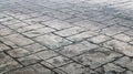 Concrete or cobblestone gray paving slabs or stones for the floor. Pavement in the city. Large gray paving tiles close up