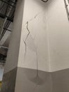Concrete column with severe cracks and water stains, indicating structural stress and potential safety concerns. Royalty Free Stock Photo