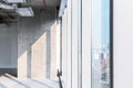 A concrete column with sunlight cast on during the interior renovation with open ceiling system work. Empty space for developer