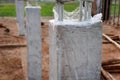 Concrete columns at the construction site are covered with plastic. Concrete curing method.