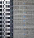 Concrete core of a tall apartment building under construction with floor numbers marked in blue paint with silver cladding on Royalty Free Stock Photo