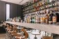 Concrete counter bar with mirror below with many brands liquors on the top and back shelf Royalty Free Stock Photo