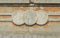 Concrete cracked pattern on the facade. three circles of stucco molding on the beige facade of the building with a crack