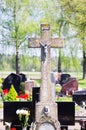 Concrete cross with crucifix in cemetery in summer