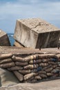 Concrete cube and sandbags on Nobbys breakwater dam in Newcastle, Australia