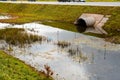 Concrete culvert pipe hole system draining sewage water near the Royalty Free Stock Photo