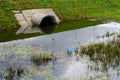 Concrete culvert pipe hole system draining sewage water near the Royalty Free Stock Photo