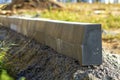 Concrete curb installation works at road construction site. Shallow DOF.