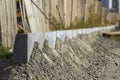 Concrete curb installation works at road construction site. Shallow DOF. Royalty Free Stock Photo