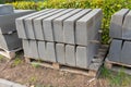 Concrete curbs are stacked on a wooden pallet, construction site Royalty Free Stock Photo