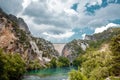 Concrete Dam among the rocks. Reservoir, hydroelectric power plant, clean electricity Royalty Free Stock Photo