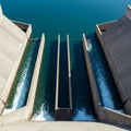 Concrete dam spillways channel water in defined paths. The structure consists of Royalty Free Stock Photo