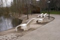 Concrete deck chairs by the lakeside in the public park Royalty Free Stock Photo