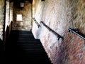 Concrete exterior stair in covered brick and stone castle wall Royalty Free Stock Photo