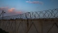 Concrete fence with barbed iron wire Royalty Free Stock Photo