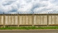 Concrete fence with barbed wire Royalty Free Stock Photo