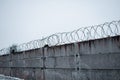 A concrete fence. Barbed wire. restricted area. Royalty Free Stock Photo