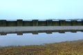 Old concrete fence by the lake in winter Royalty Free Stock Photo