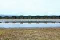 Old concrete fence by the lake in winter Royalty Free Stock Photo