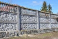 Concrete fence panel design on the stone fence foundation against blue sky Royalty Free Stock Photo