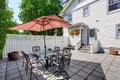 Concrete floor cozy patio area with table set and patio umbrella. Royalty Free Stock Photo