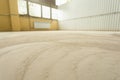 Concrete floor grinding. Construction process. Sanding a concrete floor with a sander in a warehouse