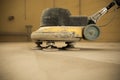 Concrete floor grinding. Construction process. Sanding a concrete floor with a sander in a warehouse