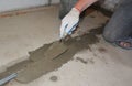 Concrete floor slab construction and leveling: a building contractor is removing steel formwork, beam and plastering it using a