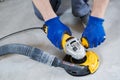 Concrete floor surface grinding by angle grinder machine