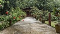 A concrete footpath leads directly to the wooden cottage.